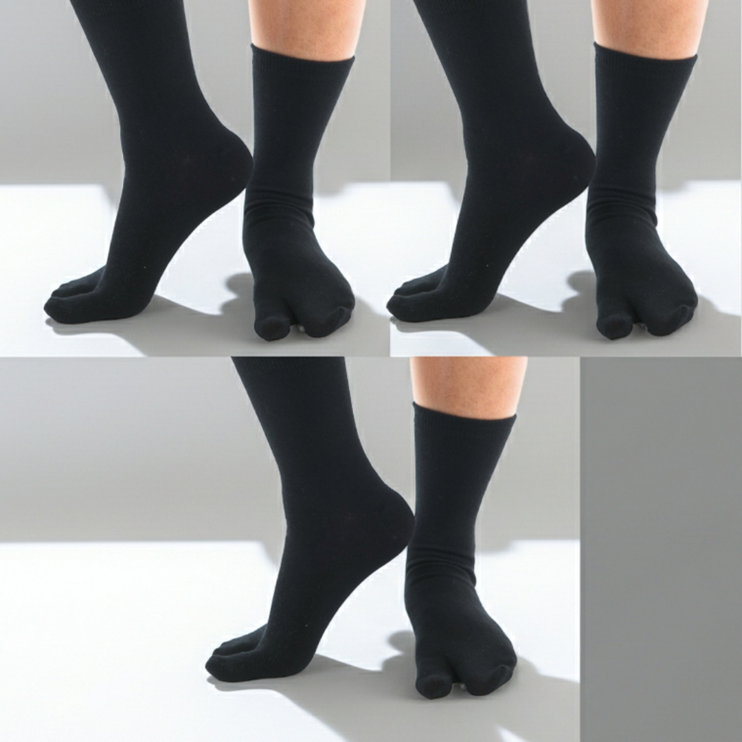Black tabi socks worn on a model's feet, shown in a split-panel studio shot against a white floor with soft shadows.