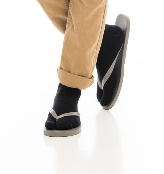 Close-up of black V-Toe athletic split-toe tabi crew socks worn on the feet